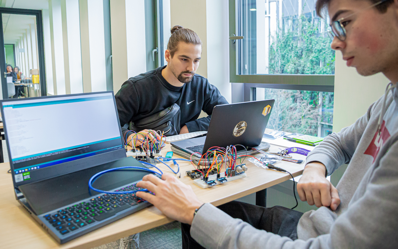 Students experimenting with electronic or network equipment